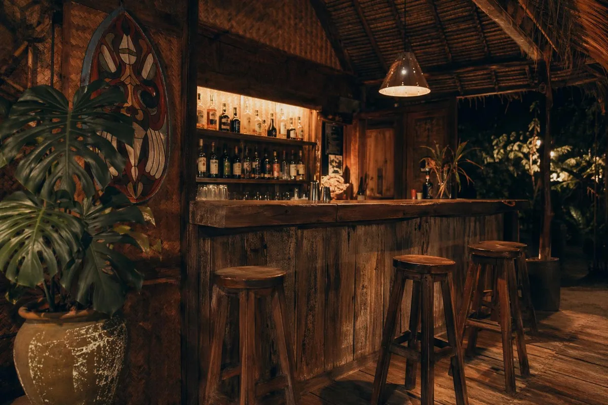 The bar lit by warm filament bulbs at night